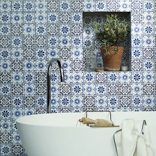 bathroom with bathtub and blur designed tile wall