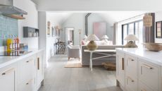 White open plan country kitchen with seating area in luxurious Cotswolds barn