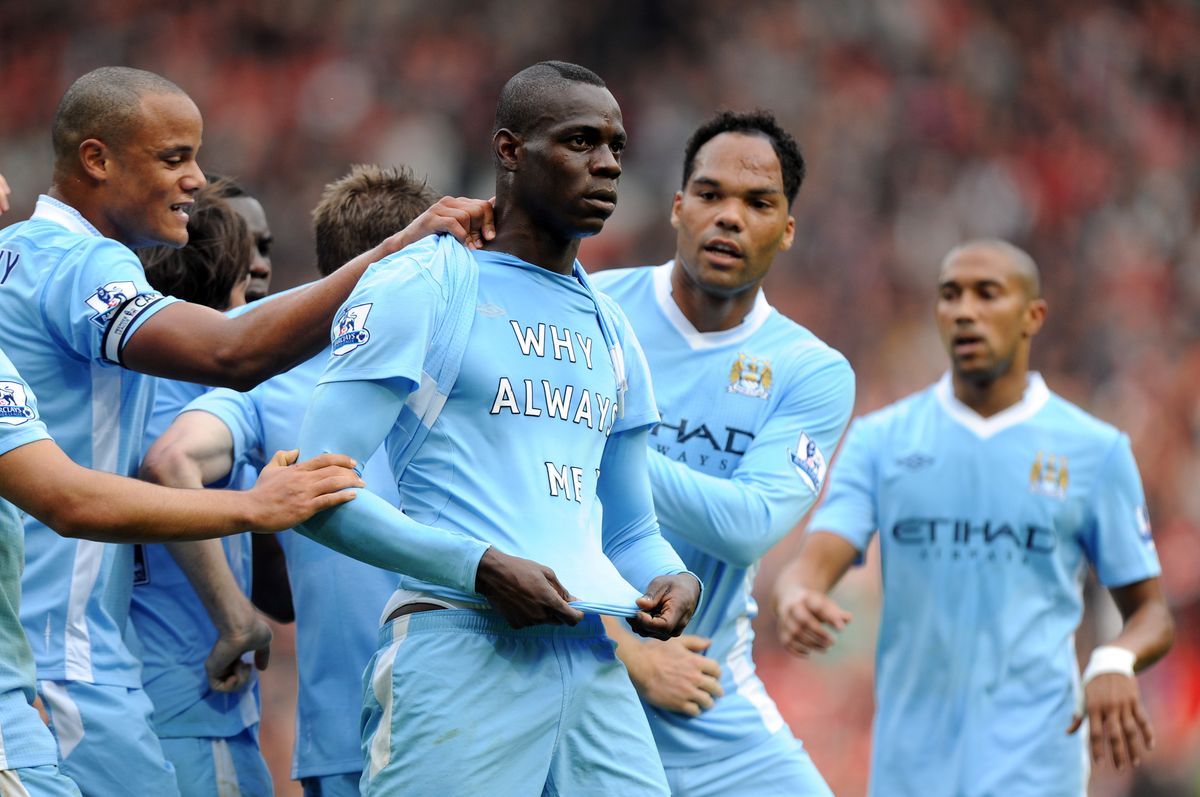 Mario Balotelli reveals a shirt with the message &#039;Why always me? on it after scoring for Manchester City against Manchester United in 2011.