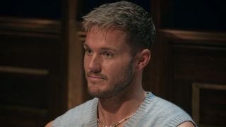Colton Underwood wearing a vest at the Round Table on The Traitors