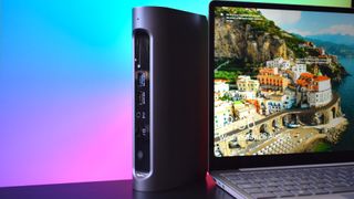 Photograph of the Satechi Thunderbolt 4 Multimedia Pro Dock standing up next to a laptop