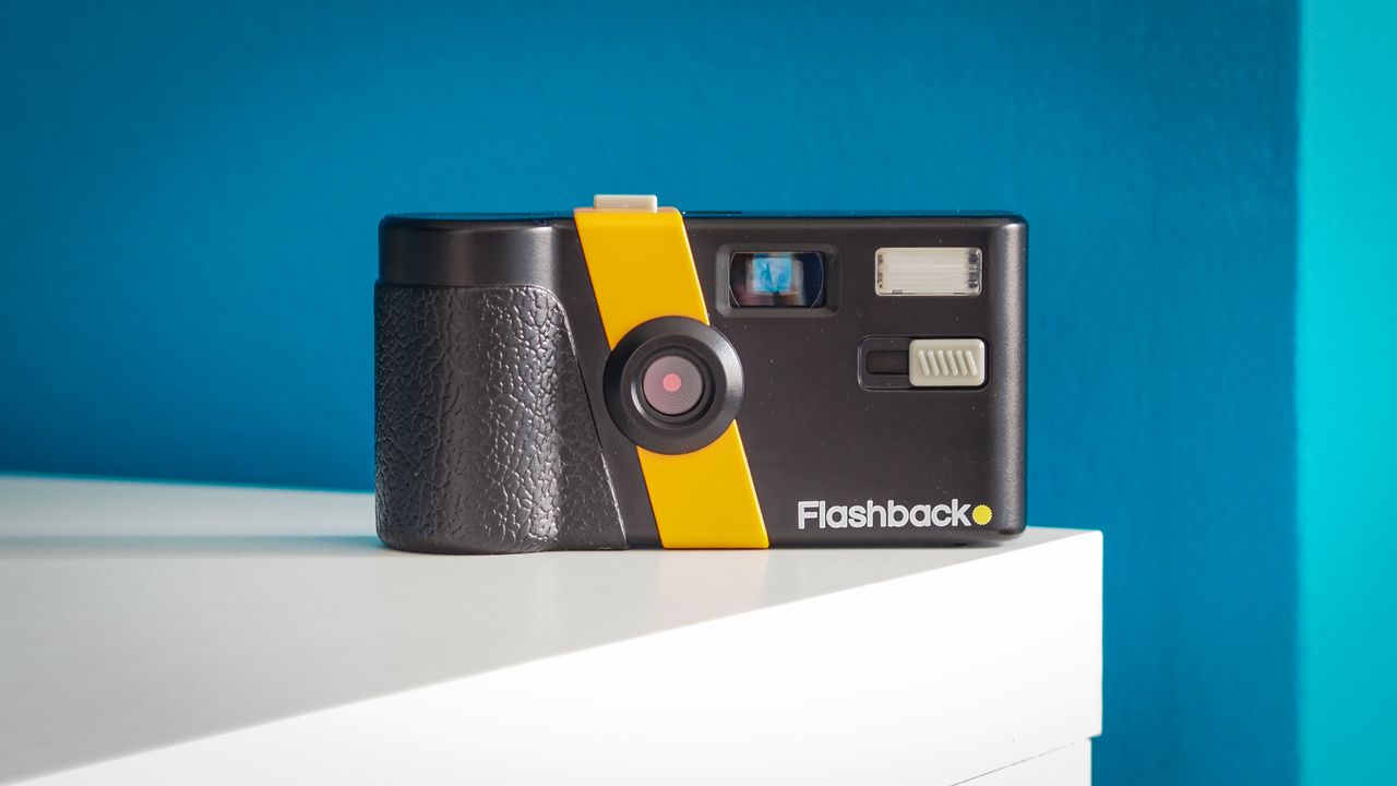 Lifestyle photo of the Flashback camera against a light blue background