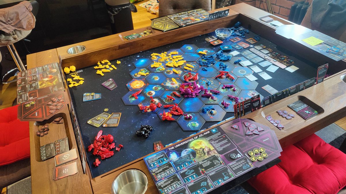 A full view of the Twilight Imperium board, tokens, and cards in use on a specialist board game wooden table