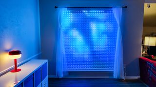 The Govee Curtain Lights Pro installed in a window showing an animated whale swimming overhead