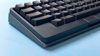 The HHKB Studio mechanical keyboard against a blue background.