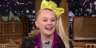 JoJo Siwa smiles as she talks to Jimmy Fallon