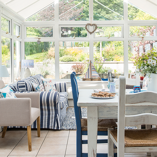 conservatory with dining table and wooden chairs