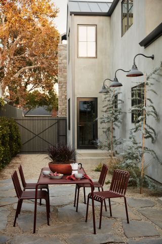 an outdoor patio with a dining table and gate