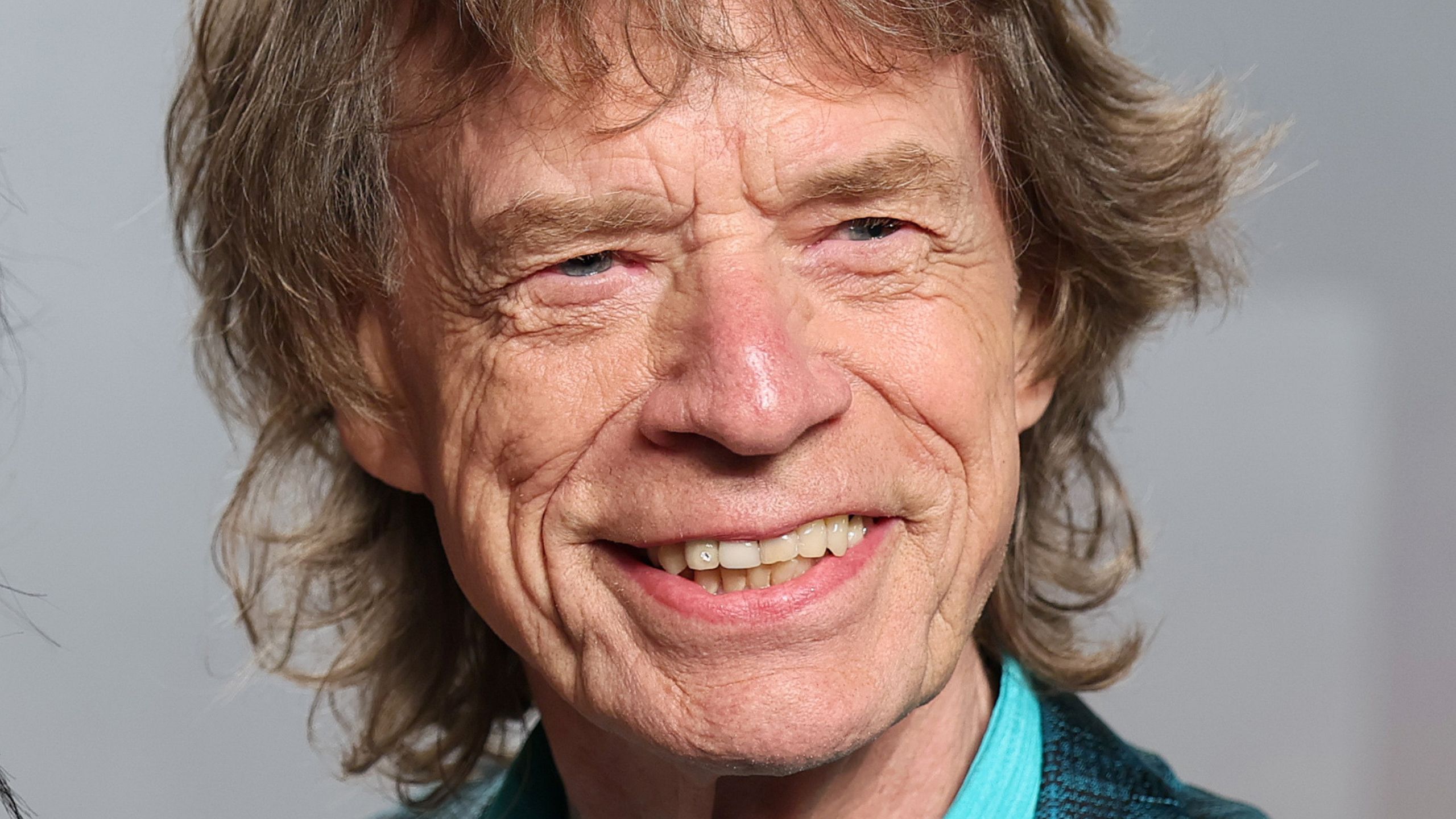 mick jagger on a gray background