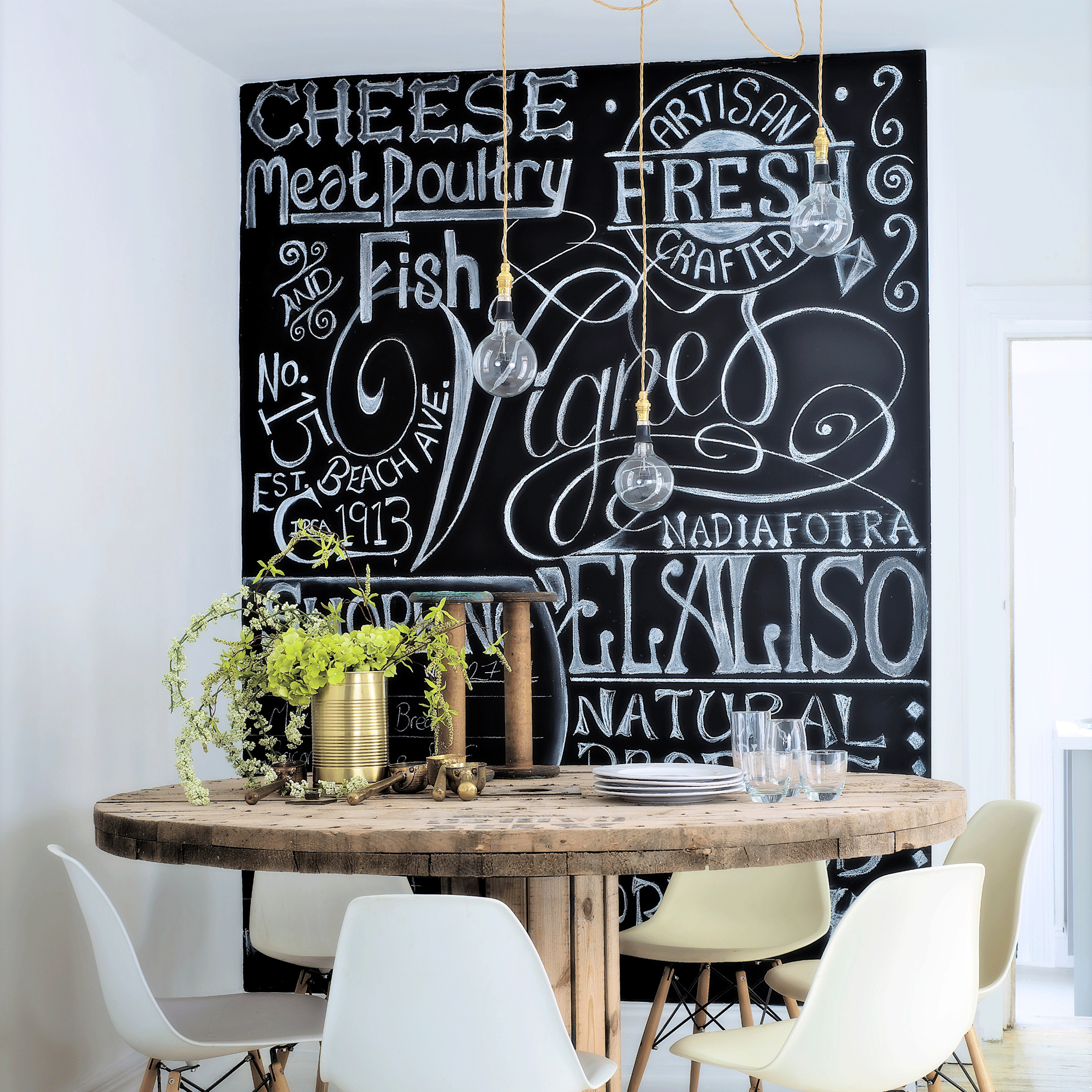 chalkboard wall with wooden table and chairs