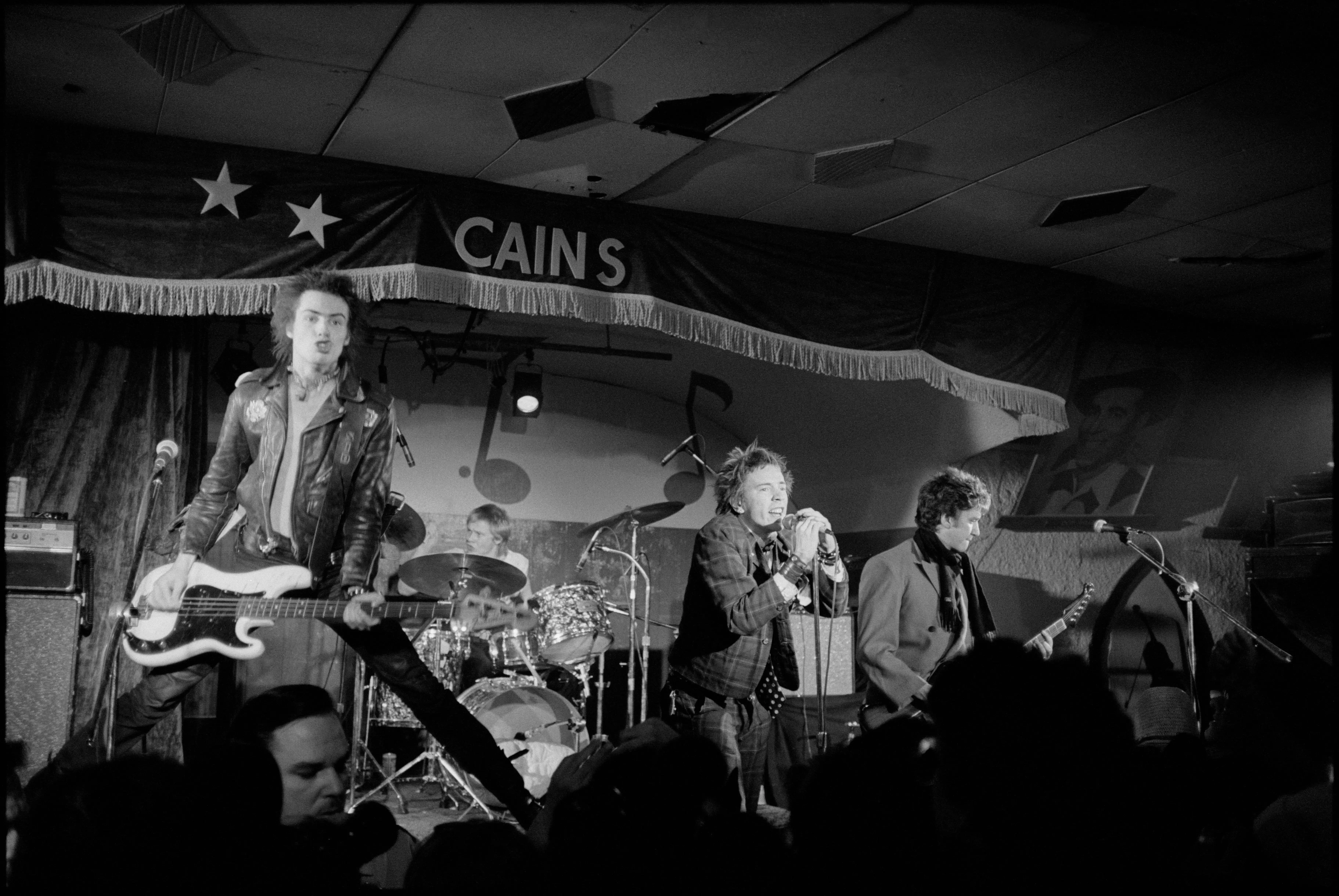 The Sex Pistols performing on stage, photographed by Roberta Bayley