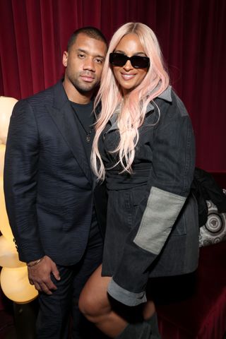 A pink-haired Ciara poses with Russell Wilson during Super Bowl 2024 Weekend.
