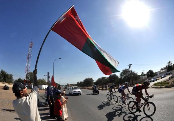 The breakaway speeds past a flag-waving fan