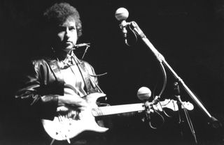 Bob Dylan plays a Fender Stratocaster during his infamous set at the 1965 Newport Folk Festival