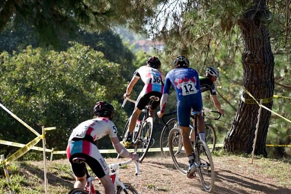 The lead group crests the hill