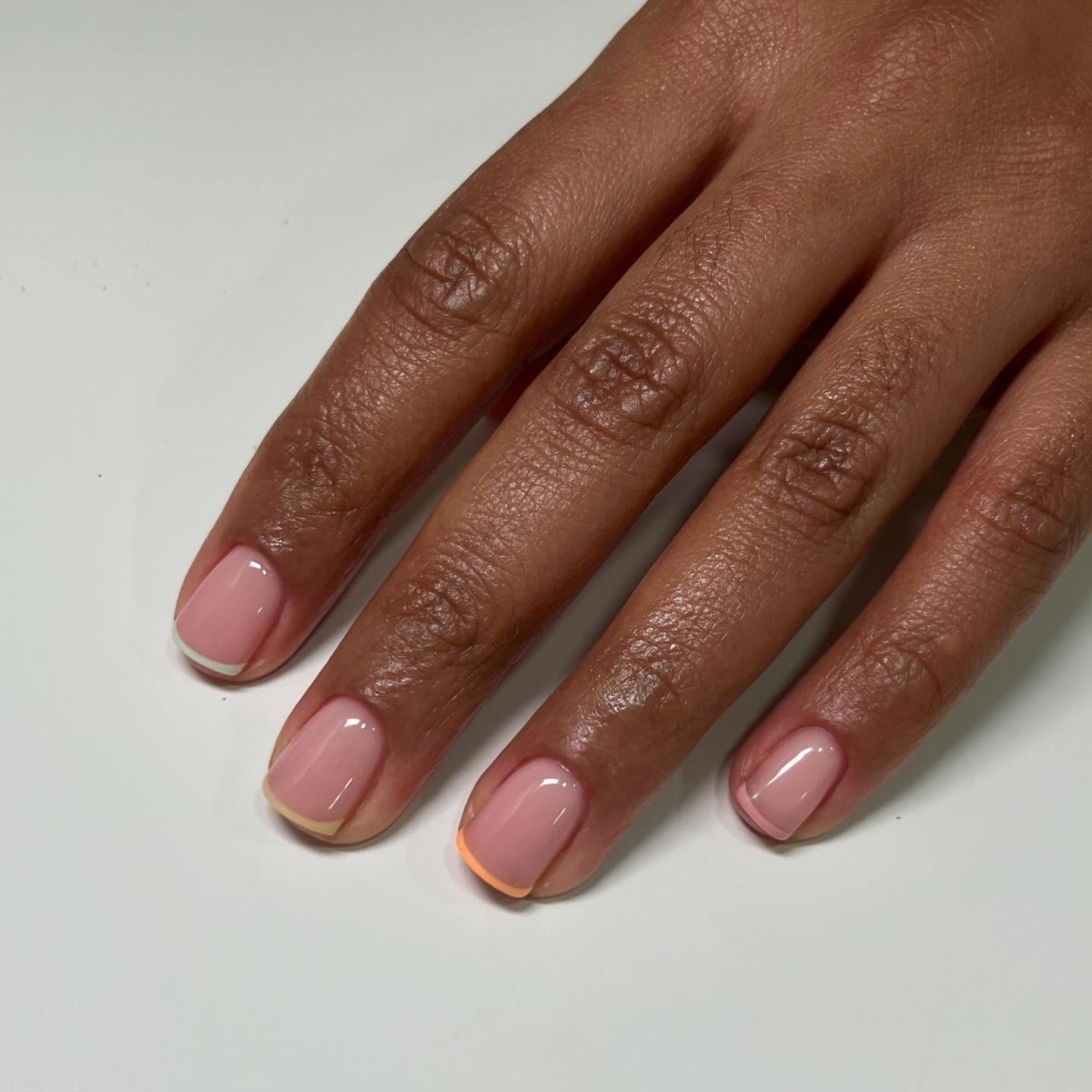 Short colorful French tip nails.