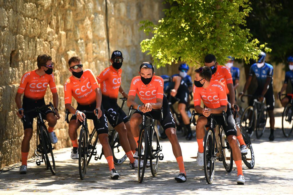 A bemasked CCC Team await the stage start