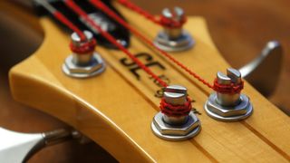 A freshly restrung four-string bass guitar