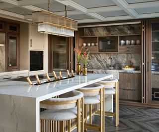 A dark wood kitchen with marble-look porcelain countertops