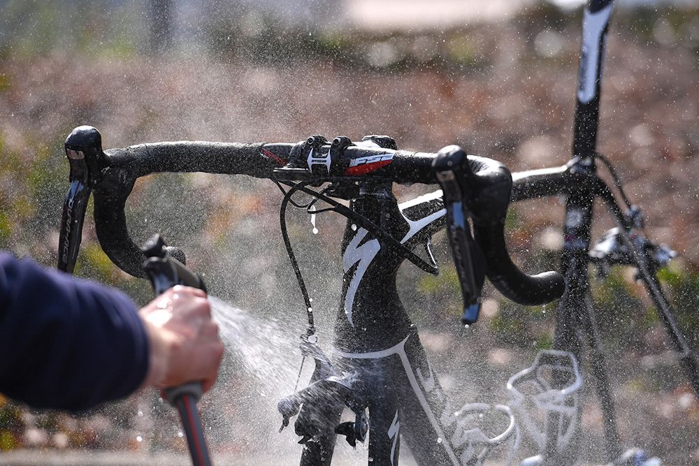 Quick-Step mechanics wash the bikes after a training ride