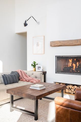 A modern living room with cassette fireplace installed into wall with white paint decor