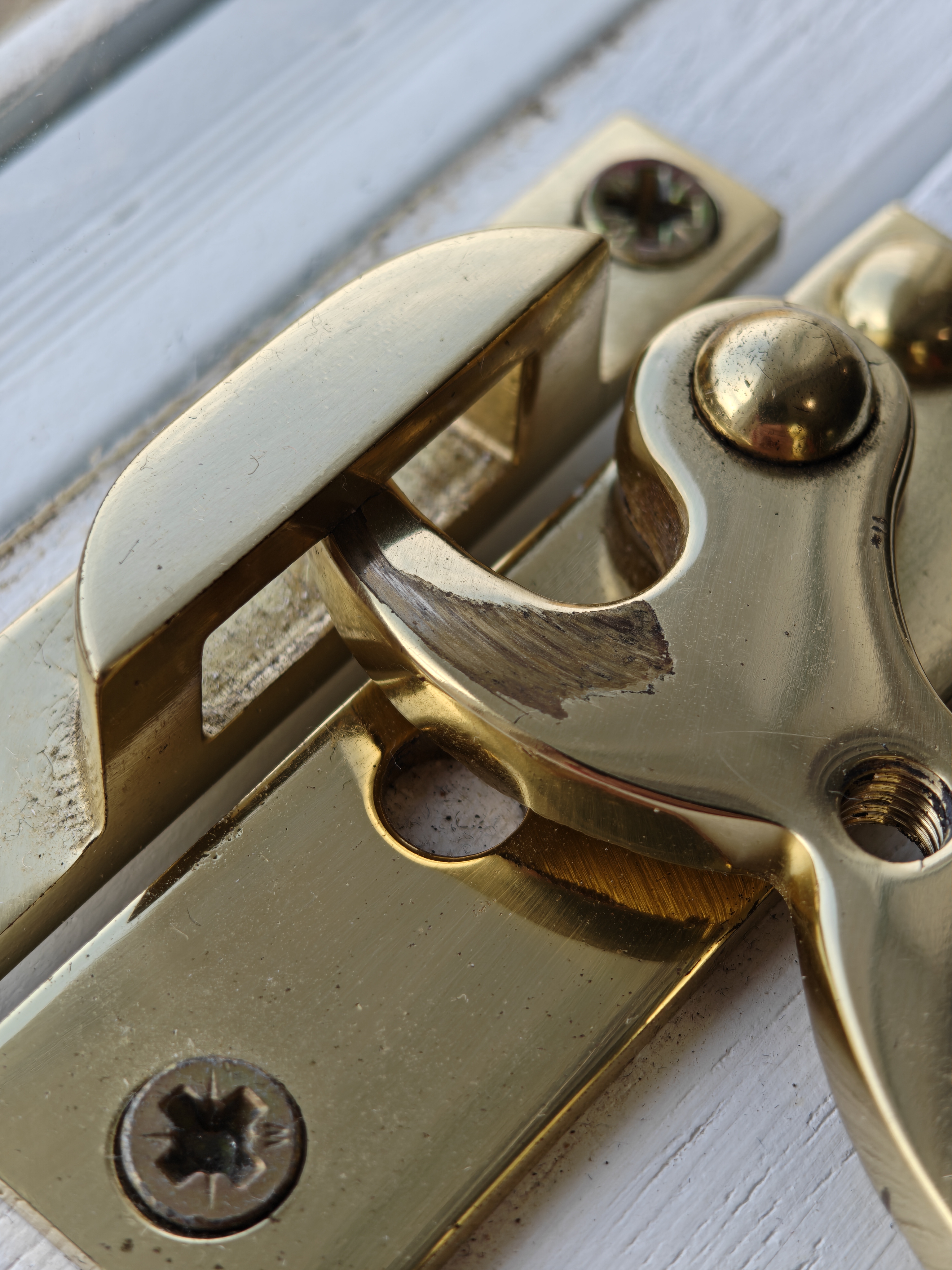 Close up of a brass window catch