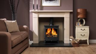 small log burning stove in white fire place
