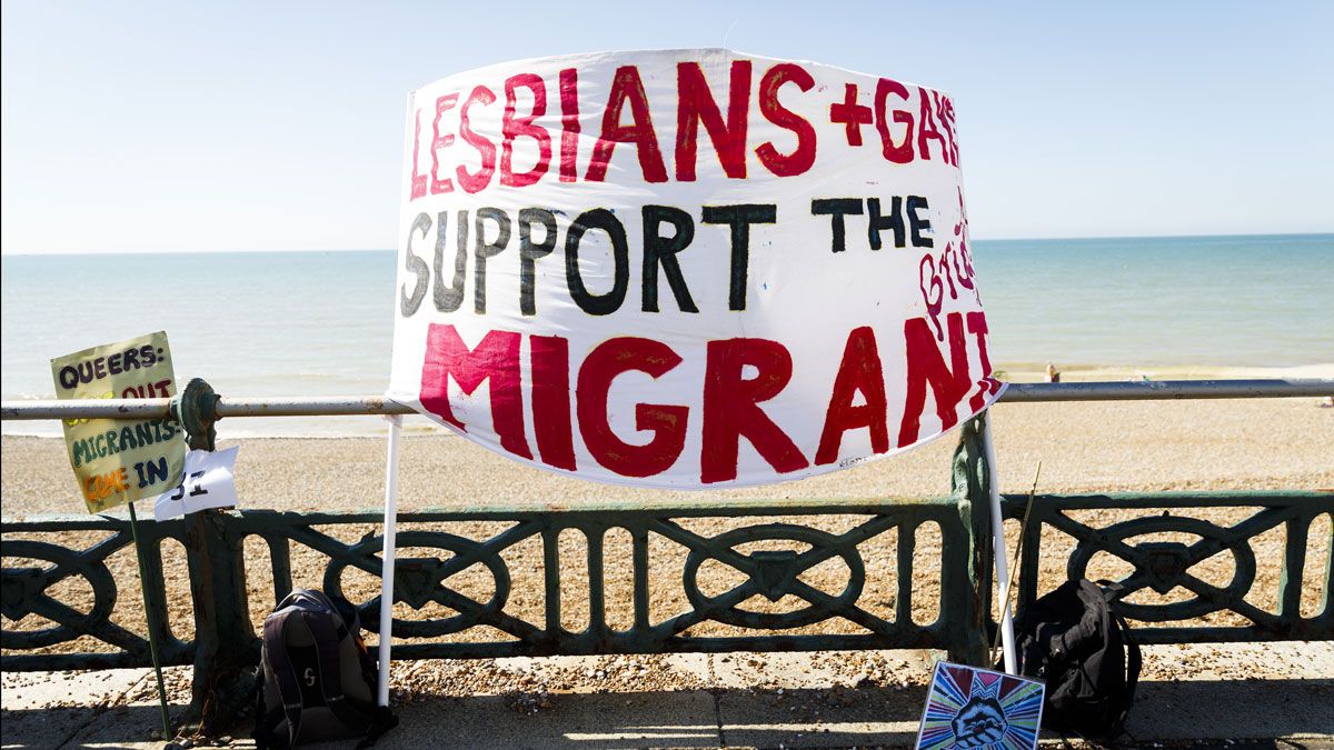 A sign defending migrants' rights during the Brighton Pride Parade on Saturday