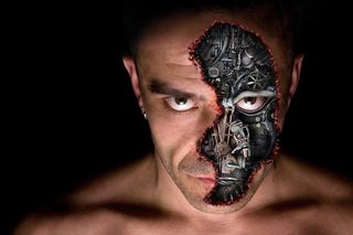 A part-human, part-robot man, in image showing his face.