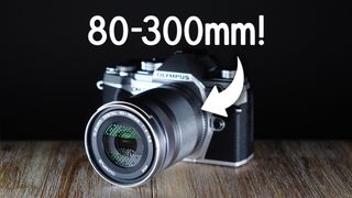 Olympus M.Zuiko 40-150mm f/4.0-5.6 R lens, mounted to an Olympus camera, with the text, "80-300mm!"