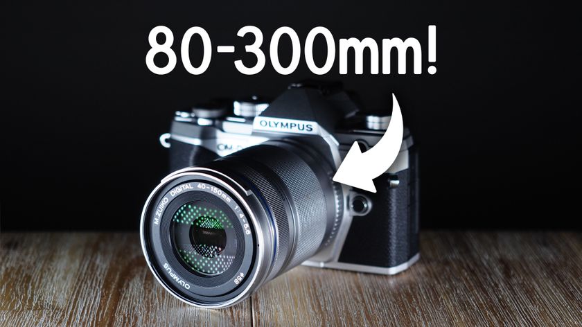 Olympus M.Zuiko 40-150mm f/4.0-5.6 R lens, mounted to an Olympus camera, with the text, &quot;80-300mm!&quot;