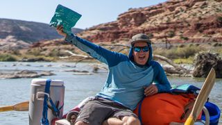 Man on raft holding PACT Outdoors