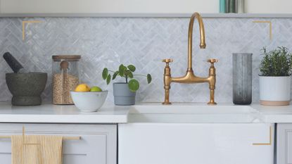 neutral kitchen with white butler sink with brass tap to highlight an article to show the things you should never pour down drains and kitchen sinks