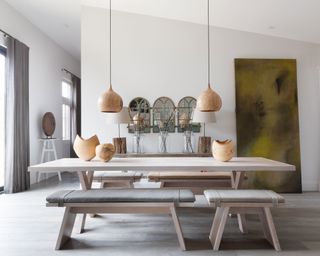 Modern rustic dining room with trestle table in luxurious Cotswolds barn