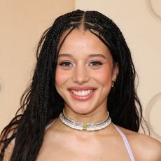 a young girl wearing long, black box braids