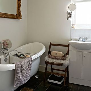 Shabby chic bathroom with vintage roll-top bath