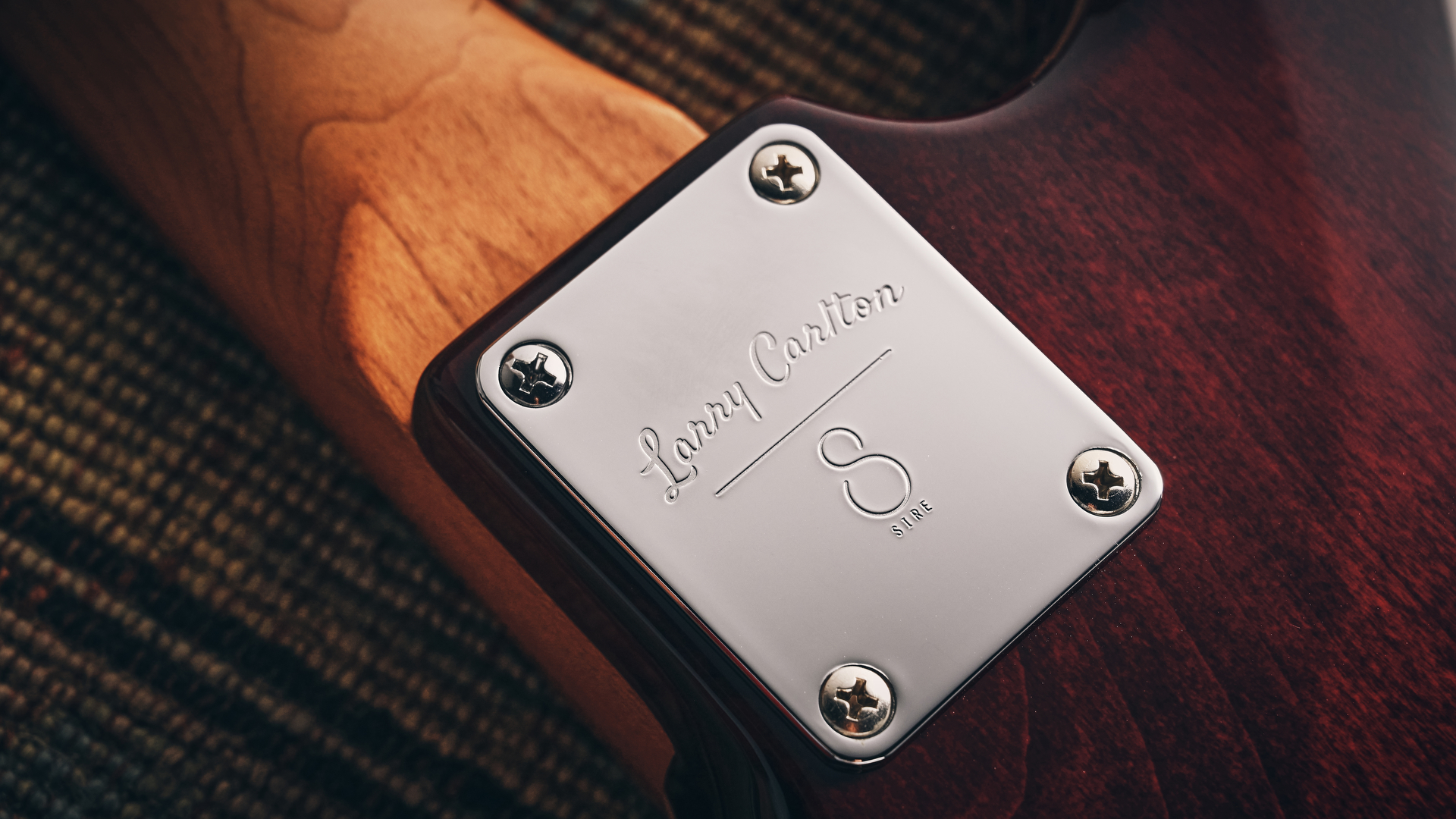 The neck plate of the Sire Larry Carlton S7 Ash Top electric guitar