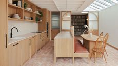 kitchen extension with wooden kitchens and herringbone brick floor with banquette seating