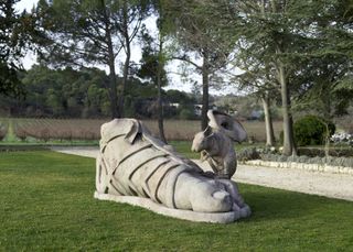Giant foot sculpture and sculpture of mouse with ear on its back