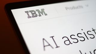 IBM logo pictured on a webpage on a tablet screen with AI assistant promotional materials. 