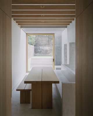 Bespoke timber kitchen table at Islington House by McLaren Excell