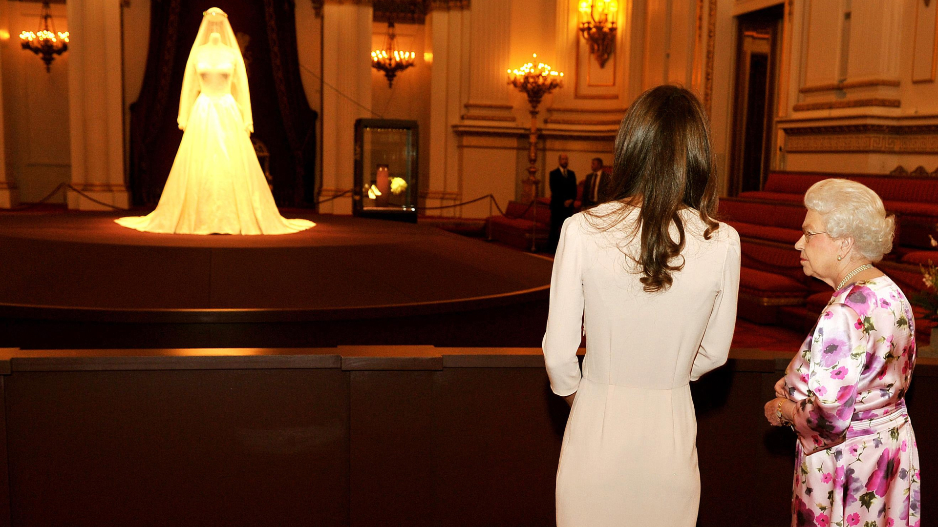Queen Elizabeth and Kate Middleton view the royal wedding dress. 