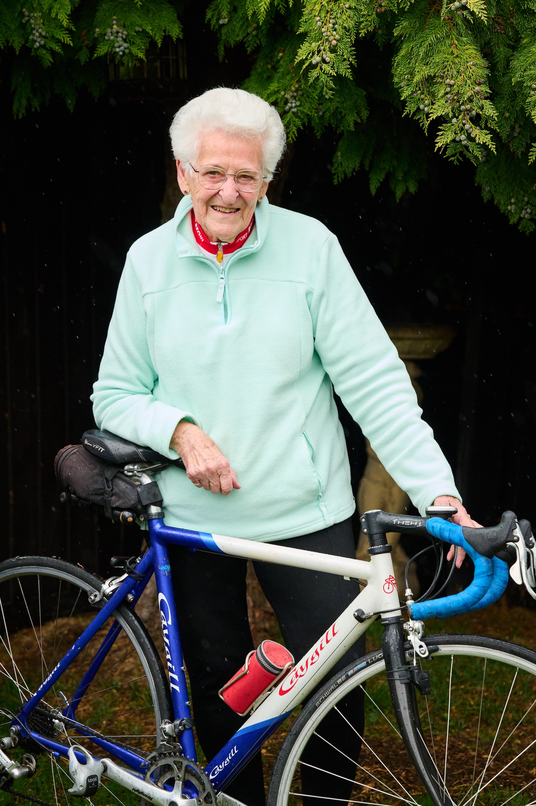 Shirley Hockridge standing with her bike, wearing a light blue sweatshirt