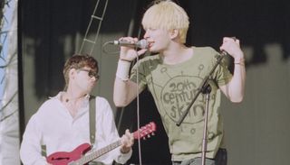 Radiohead's Ed O'Brien (left) and Thom Yorke perform onstage at the 1994 Reading Festival in England on August 27, 1994