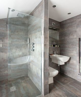 bathroom with grey wall and ceramic flooring