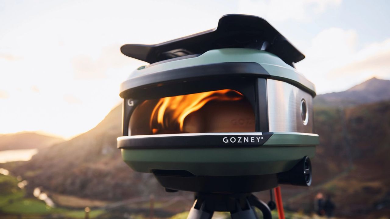 A Gozney Tread pizza oven in front of a hilly landscape