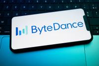 The ByteDance logo displays on a smartphone screen placed on a laptop keyboard illuminated by blue light. TikTok's parent company announces on February 10, 2026, the launch of Seedream 5.0, an image-generating AI capable of competing with industry leaders in Creteil, France, on February 12, 2026. (Photo by Samuel Boivin/NurPhoto via Getty Images)