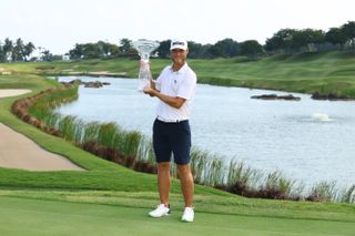 Jesper Svensson holds up the 2024 Porsche Singapore Classic trophy