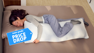 A woman sleeping on the side hugging the Coop Cool+ Cooling Body pillow