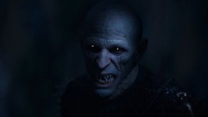 The Blood of Dawnwalker trailer showing the vampire Brencis growling while standing in a shadow. 
